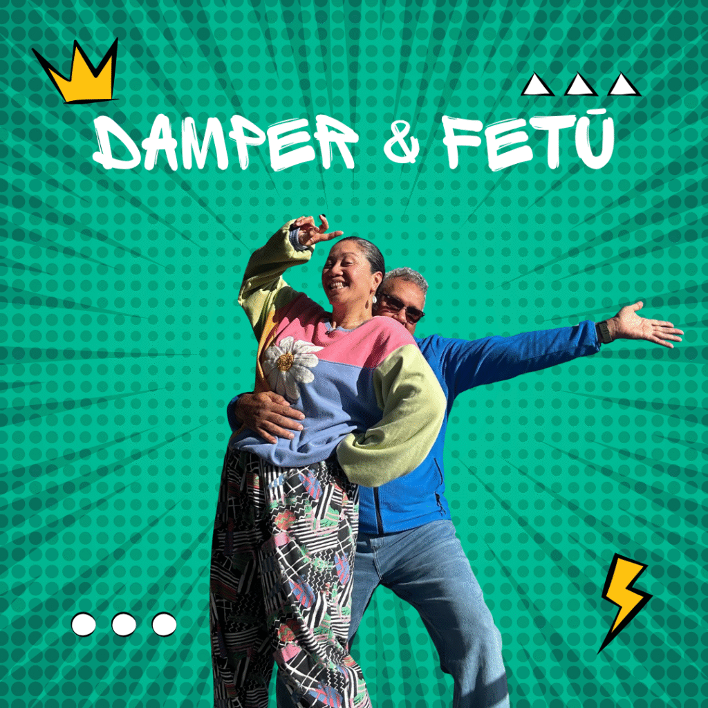 Mark and Maryann of Damper & Fetū smiling and striking a playful pose against a vibrant teal comic-style background with bold white text reading “Damper & Fetū.” Surrounded by pop-art icons including a crown, lightning bolt, and geometric symbols, representing creativity, cultural fusion, and joy.