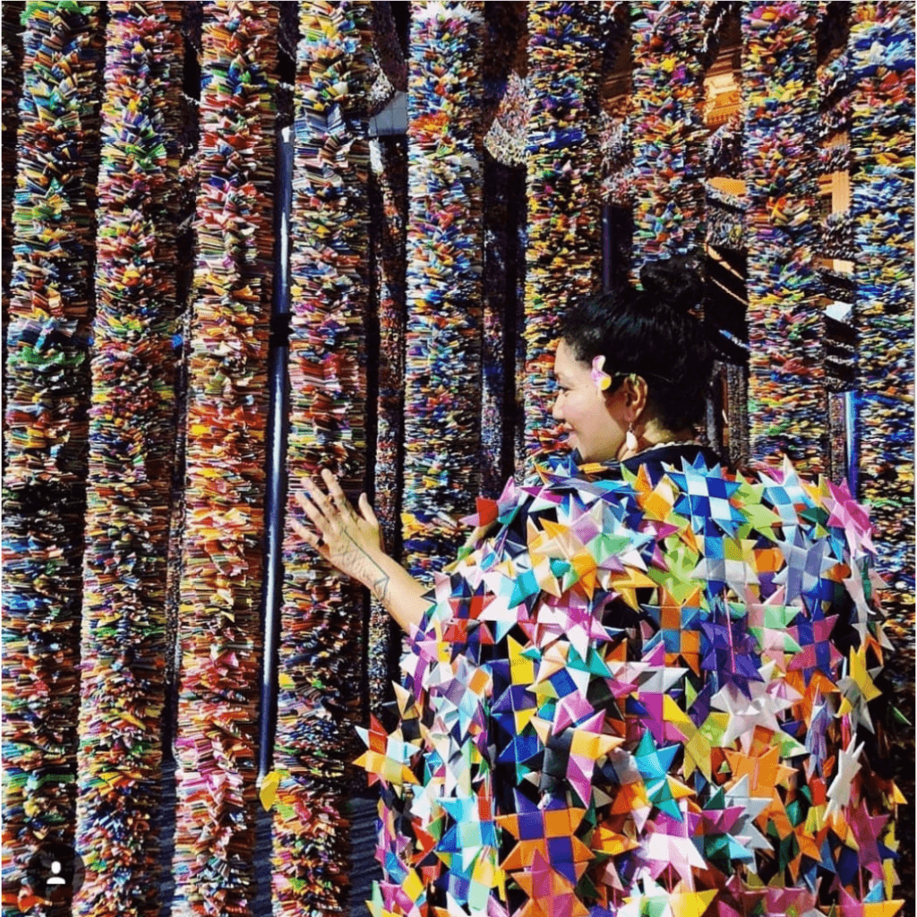 Image of One Billion Stars Founder, Maryann Talia Pau, wearing a star cape at the One Million Stars installation GC2018